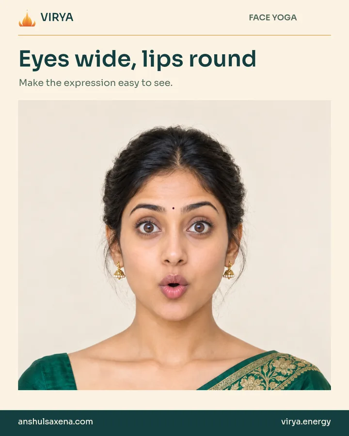 Fictional young adult Indian woman in an embroidered emerald silk saree demonstrates Eyes wide, lips round.